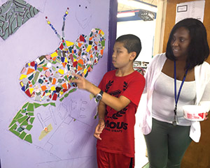 Student and teacher making mosaic mural - private special education school WIllingboro NJ