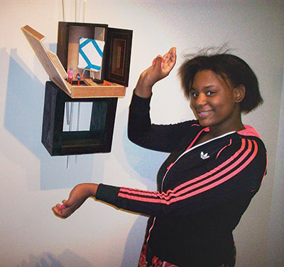 Female GPA High School student showing off her artwork at Virtua Hospital exhibition