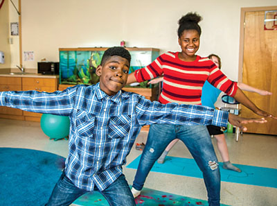 GPA male and female students in yoga class