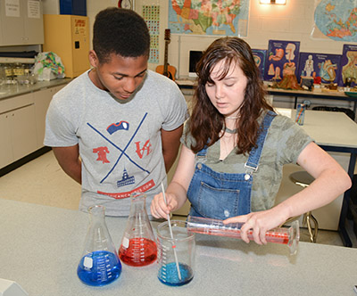 GPA students working with beakers and science lab equipment