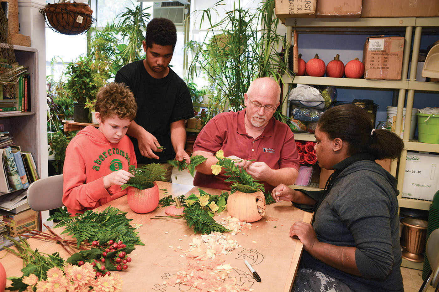 Horticulture Program Supervisor David Hamilton works with GPA students on floral arrangements for use in the community