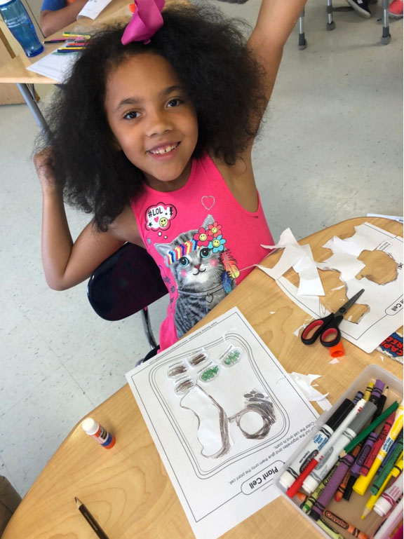 Elementary school female student participating in the GPA Science Fair preparations