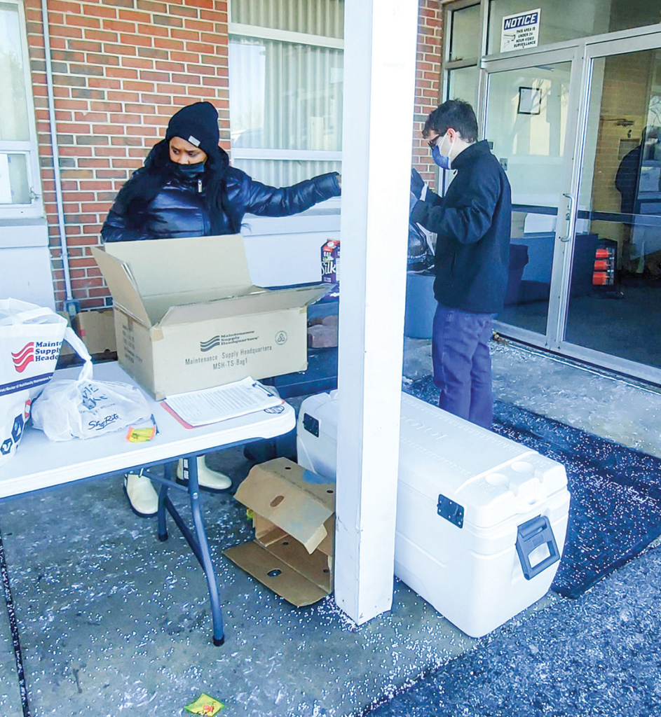 Garfield Park Academy students working with DelVal Church congregants in a food drive organized at the Willingboro church