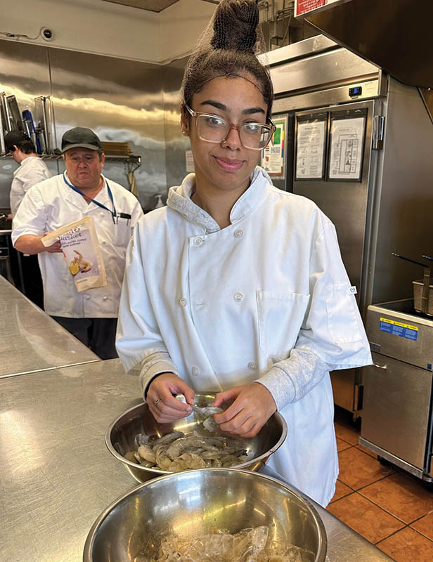 Female High School student working in GPA's Culinary class, part of the school's transition curriculum.