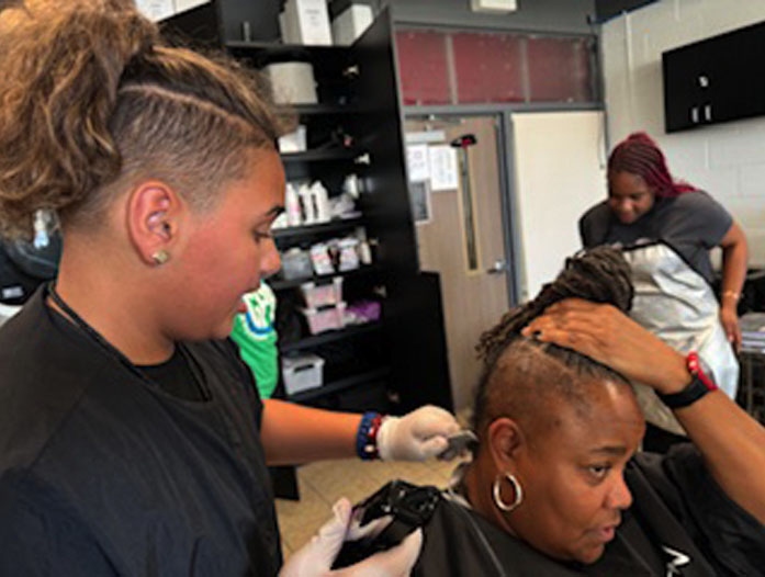 Student working on cosmetology skills at Garfield Park Academy